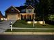 Two story home exterior featuring well maintained lawn, brick and siding accents, at dusk at 5637 Valley Loop, Fairburn, GA 30213