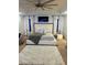 Stylish bedroom with a large bed, plush rug, ceiling fan, and elegant decor, creating a cozy and inviting space at 5637 Valley Loop, Fairburn, GA 30213