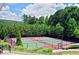 Well maintained tennis courts surrounded by tall lush green trees in a community at 5637 Valley Loop, Fairburn, GA 30213