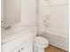 Bright bathroom featuring a white vanity, toilet, and shower-tub combination at 7127 Brushwood Bend (Lot 44), Lithonia, GA 30058