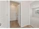 Hall bathroom with modern white fixtures, wood look flooring, and bright lighting at 7127 Brushwood Bend (Lot 44), Lithonia, GA 30058