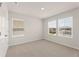 Bright bedroom with plush carpet, windows offering exterior views, and a closet at 7127 Brushwood Bend (Lot 44), Lithonia, GA 30058