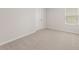 Comfortable bedroom featuring neutral carpet, a window, and a closet at 7127 Brushwood Bend (Lot 44), Lithonia, GA 30058