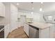 Bright kitchen with white cabinets, granite countertops, stainless appliances, and a large island at 7127 Brushwood Bend (Lot 44), Lithonia, GA 30058