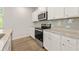 Bright kitchen featuring white cabinets, granite countertops, and stainless appliances at 7127 Brushwood Bend (Lot 44), Lithonia, GA 30058
