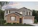Charming two-story home with a brick and siding exterior, complemented by a well-manicured lawn and front yard landscaping at 7133 Brushwood Bend (Lot 43), Lithonia, GA 30058