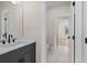 Bathroom featuring a modern vanity and open doorway to a hallway at 11350 Bennett Ln, Johns Creek, GA 30097