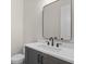 Modern bathroom features a vanity with dark gray cabinets, white quartz countertop, and black faucet at 11350 Bennett Ln, Johns Creek, GA 30097