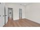 Spacious bedroom featuring light wood floors and two white doors, creating a minimalist and clean aesthetic at 11350 Bennett Ln, Johns Creek, GA 30097