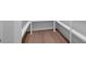 Walk-in closet with wood floors and built-in shelving at 11350 Bennett Ln, Johns Creek, GA 30097