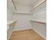 Walk-in closet with built-in shelving and hanging rods for optimized storage and organization at 11350 Bennett Ln, Johns Creek, GA 30097