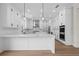 Modern kitchen with white cabinets, marble countertops, and stainless steel appliances at 11350 Bennett Ln, Johns Creek, GA 30097