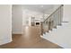 Open-concept living space with hardwood floors and staircase with rod iron, perfect for modern living at 11350 Bennett Ln, Johns Creek, GA 30097