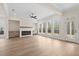 Bright living room featuring large windows and a fireplace at 11350 Bennett Ln, Johns Creek, GA 30097