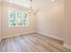 Dining room with a window with backyard views and a modern chandelier at 1979 Deco Dr, Kennesaw, GA 30144