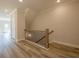 Hallway with hardwood floors, wood banister, and natural light at 1979 Deco Dr, Kennesaw, GA 30144