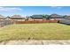 Wide-angle photo of the level backyard with a privacy fence and green grass at 385 Hinton Chase Pkwy, Covington, GA 30016