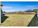 A wide-angle view of the level, grassy backyard with privacy fence on a clear day at 385 Hinton Chase Pkwy, Covington, GA 30016