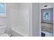Cozy bathroom featuring a white tub, toilet, and tile floors at 385 Hinton Chase Pkwy, Covington, GA 30016
