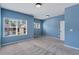 Bright blue bedroom with large windows and plush carpeting for a cozy and inviting space at 385 Hinton Chase Pkwy, Covington, GA 30016