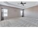 Spacious bedroom with a tray ceiling, two windows, and neutral-toned walls, creating a serene and inviting atmosphere at 385 Hinton Chase Pkwy, Covington, GA 30016