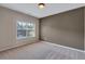 Neutral bedroom with large window and plush carpeting providing ample natural light at 385 Hinton Chase Pkwy, Covington, GA 30016