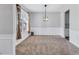 Dining room with neutral carpet, decorative wainscoting, and natural light at 385 Hinton Chase Pkwy, Covington, GA 30016
