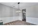 Formal dining room featuring wainscoting and a modern light fixture at 385 Hinton Chase Pkwy, Covington, GA 30016