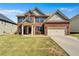 Charming two-story brick home with a well-manicured lawn and two-car garage at 385 Hinton Chase Pkwy, Covington, GA 30016