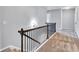 Bright hallway showcasing wooden railing, carpet, and neutral paint tones for an inviting transition between rooms at 385 Hinton Chase Pkwy, Covington, GA 30016