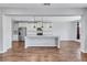 Kitchen with stainless steel appliances, granite counters, and island with pendant lighting at 385 Hinton Chase Pkwy, Covington, GA 30016