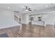 Open concept living room and kitchen with ceiling fan and staircase at 385 Hinton Chase Pkwy, Covington, GA 30016
