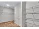 Large walk-in closet featuring tan carpet, white walls and door, and wire shelving at 385 Hinton Chase Pkwy, Covington, GA 30016