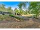 Landscaped backyard featuring a small bridge, seating, mature trees, and lush green plants at 4067 Silver Fir Ct, Marietta, GA 30066