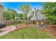 Private fenced-in yard, featuring a stone fire pit and lush landscaping at 4067 Silver Fir Ct, Marietta, GA 30066
