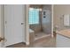 Bathroom showcasing tiled floors and walls, plus a glass block window for natural light at 4067 Silver Fir Ct, Marietta, GA 30066