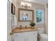 Bright bathroom features vanity with granite countertop, white cabinets and a large mirror at 4067 Silver Fir Ct, Marietta, GA 30066