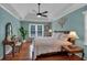 Primary bedroom with tray ceilings, fan, hardwood floors and lots of natural light at 4067 Silver Fir Ct, Marietta, GA 30066