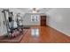 Well-lit home gym featuring hardwood floors, workout equipment, and natural light at 4067 Silver Fir Ct, Marietta, GA 30066