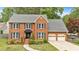 Charming two-story brick home with well-manicured lawn and attached two-car garage, offering classic curb appeal at 4067 Silver Fir Ct, Marietta, GA 30066