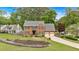 Well-maintained brick home with a two-car garage, landscaped front yard, and inviting curb appeal in a serene setting at 4067 Silver Fir Ct, Marietta, GA 30066