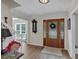 Welcoming foyer with hardwood floors, staircase, decorative clock, and an open view into adjacent spaces at 4067 Silver Fir Ct, Marietta, GA 30066
