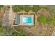 Aerial view of a sparkling blue community pool with tables, lounge chairs, and parking at 4067 Silver Fir Ct, Marietta, GA 30066