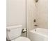 Bathroom featuring tile surround, shower head and white toilet at 510 Suwanee Pass Ln, Suwanee, GA 30024