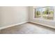 Neutral bedroom space featuring plush carpet and a window providing natural light at 510 Suwanee Pass Ln, Suwanee, GA 30024