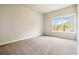 Cozy carpeted bedroom featuring a bright window providing natural light and street views at 510 Suwanee Pass Ln, Suwanee, GA 30024