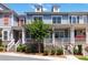Charming townhome featuring a brick foundation, inviting porch, and well-maintained landscaping at 510 Suwanee Pass Ln, Suwanee, GA 30024