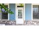 Close-up of a stylish front door with windows and blue siding, creating a welcoming entrance at 510 Suwanee Pass Ln, Suwanee, GA 30024