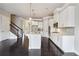 Open-concept kitchen boasts a large island, stainless appliances, and dark hardwood floors at 510 Suwanee Pass Ln, Suwanee, GA 30024