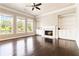 Bright living room with fireplace, built-ins, and windows offering backyard views at 510 Suwanee Pass Ln, Suwanee, GA 30024